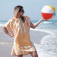 fille sur la plage en poncho microfibre orange à rayures